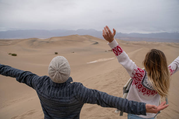 istock Couple embraces nature on sand dunes 1285618792