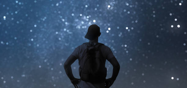 istock Man admires the mesmerizing night starry sky. 1285619578
