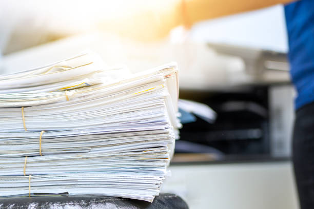 istock The papers stacked waiting to be copied with a copier machine. 1285620093