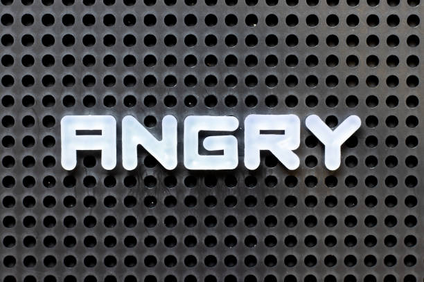 istock White color alphabet with word angry on black pegboard background 1285621052