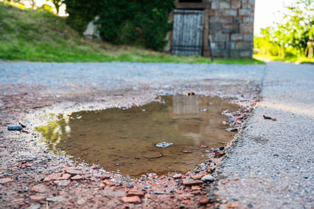 istock A selective focus shot of a puddle on an asphalt road 1285622256