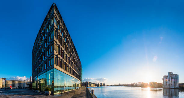 istock Modern office building soaring into blue sky panorama Copenhagen Denmark 1285623177