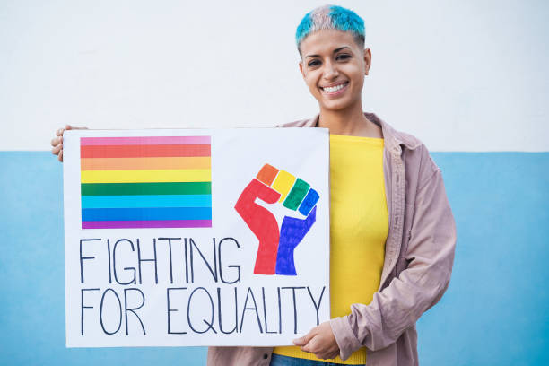 Happy lesbian woman at gay pride parade holding lgbt banner - Focus on face Happy lesbian woman at gay pride parade holding lgbt banner - Focus on face bisexuality stock pictures, royalty-free photos & images