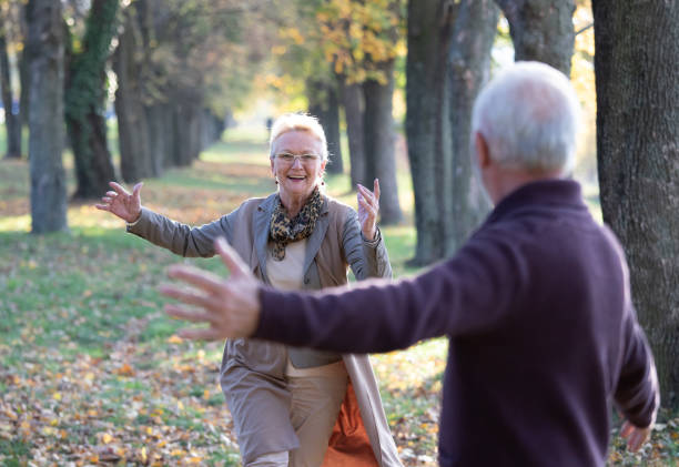 istock Senior couple running in hug in park 1285628811