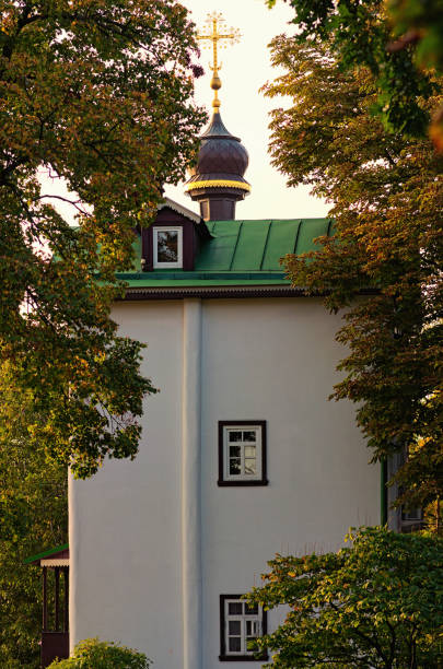 istock Scenic landscape view of the ancient tower during sunset. Trinity Monastery of St. Jonas. Tree leaves border. Natural frame. Hryshko National Botanical Garden, Kyiv 1285629729