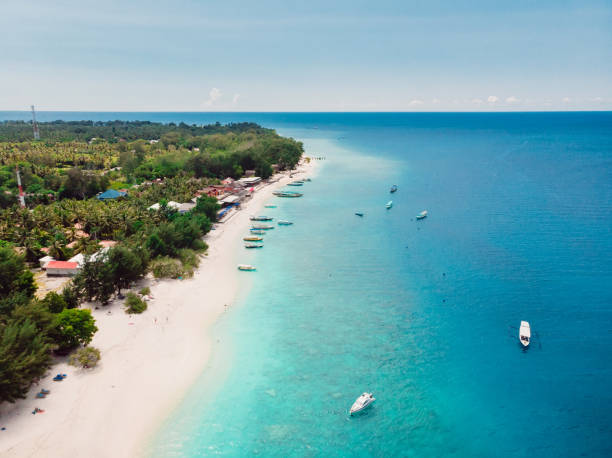istock Tropical island with beach and turquoise ocean. Aerial view. 1285629802
