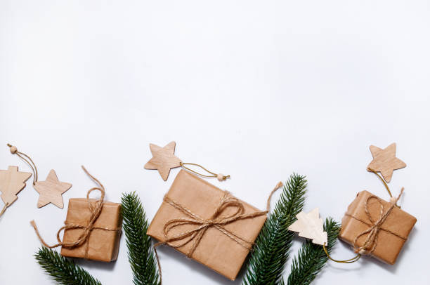 istock Christmas Composition with Craft Gift Boxes and Decorations on Light Background 1285631175