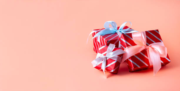 istock Christmas Red Striped Gift Boxes on Pink Background. Creative Minimal Composition. Banner 1285631183