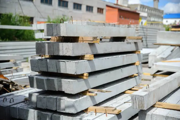 Reinforced concrete lintels are located at the warehouse of the plant of reinforced concrete products and structures