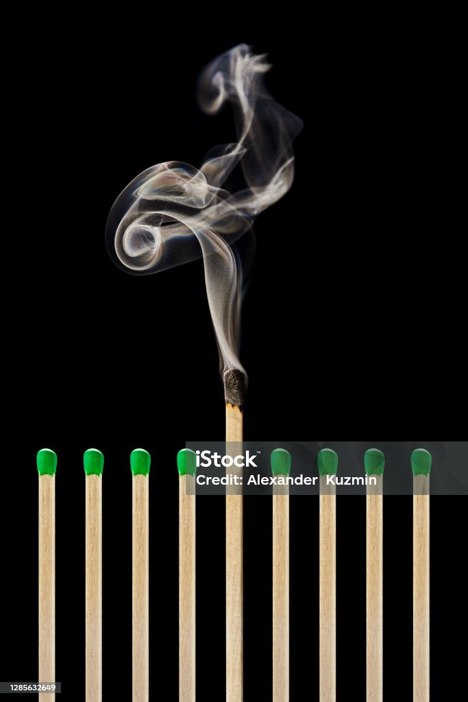 One extinguished match in a group of green matches, emotional burnout, stress, work-life balance Close-up of one extinguished match in a group of green matches. The concept of burnout, stress, work-life balance, free space for text. Match - Lighting Equipment Stock Photo