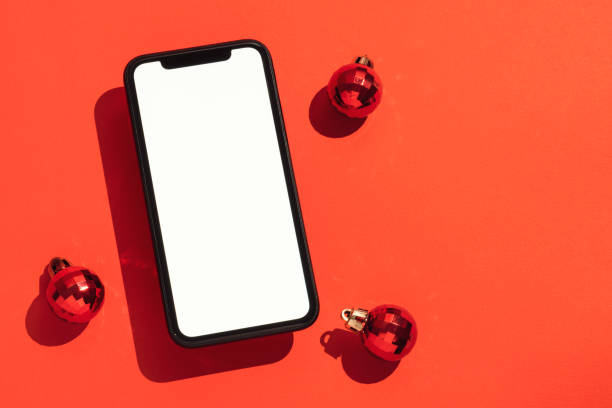istock Smart phone mockup, template on red background with Christmas balls 1285634650
