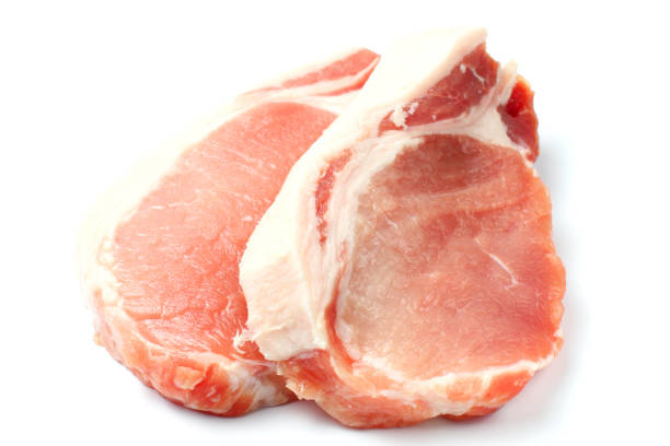 istock Raw pork meat steak closeup on a white background, top view, flat lay. isolate. 1285634867