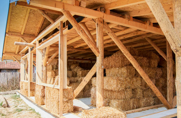 istock Straw bale House construction. Eco friendly home 1285635024