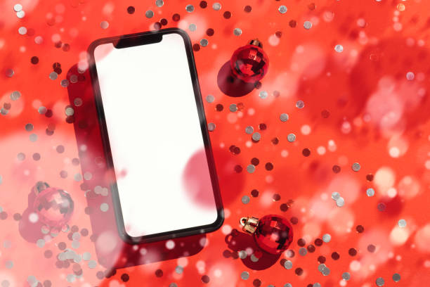 istock Smart phone mockup, template on red background with Christmas balls and glitter 1285635038