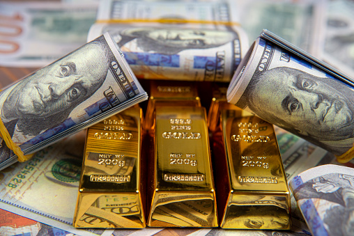 American currency Dollar and Gold ingot combinations. Close up for dollar and gold ingot