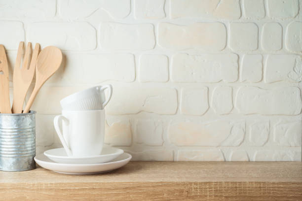 istock Kitchen background with dishware, utensils, cup and plate on wooden shelf 1285637545