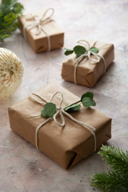 istock Christmas gift boxes wrapped with brown kraft paper and decorated with eucalyptus leaves. 1285642483