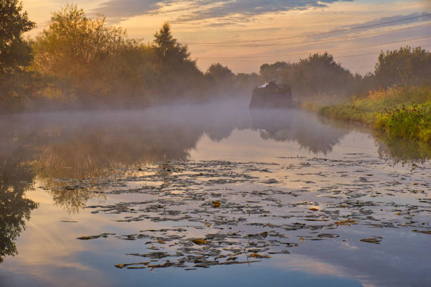 Foggy morning on the Bridgewater canal, Smoky water of the Bridgewater canal at dawn, fog, smoke, cold, humidity, frost , canal, water, reflection, man made, dawn,  sky, nature barge, transport, river, boat, vessel, Winter, cold