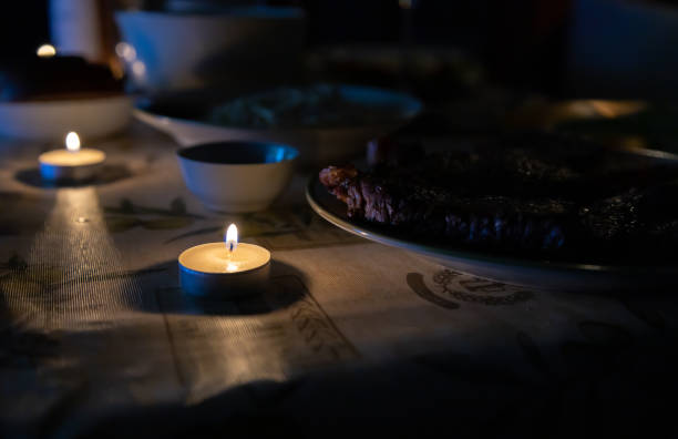 istock candle is lit on a holiday table in a dark room 1285643800