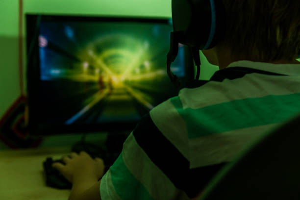 istock rear view of a teenager playing computer games 1285643848