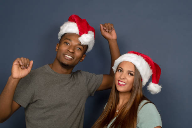 christmas couple wearing santa claus hat happy holiday young couple christmas hat santa claus family for holiday celebrations mum new boyfriend stock pictures, royalty-free photos & images