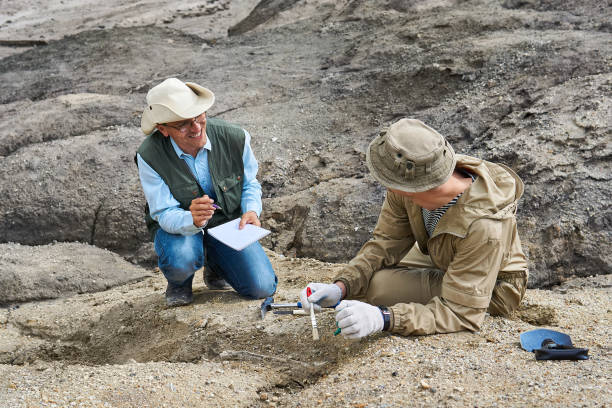 istock two paleontologists in the desert discuss the find and take notes in a field notebook 1285645120