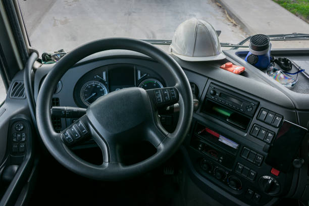 Personal protective equipment, PPE. Personal protective equipment in the cabin of a truck that transports dangerous goods, consisting of a helmet, protective glasses, gas mask and an explosimeter. semi truck audio stock pictures, royalty-free photos & images