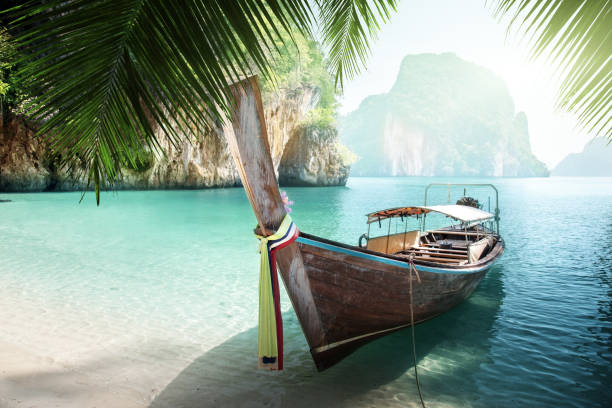 istock long boat on island in Thailand 1285653511