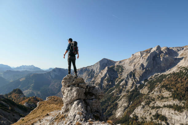 istock Hochschwab - A man standing at a sharp and narrow rock 1285654552