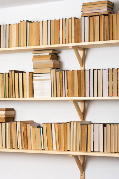 istock Bookshelves with hardback overturned books 1285654975