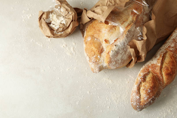 istock Fresh baked bread and flour on white background 1285655117