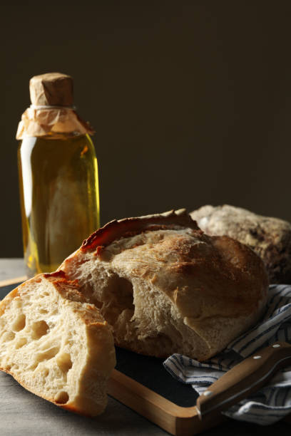 istock Concept of bakery products with fresh bread on gray table 1285655278