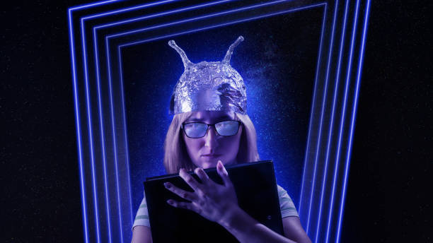 Girl in a foil hat against fantastic space theme background Girl in a foil hat against fantastic space theme background. Conspiracy theories, fantasy and mysticism theme image tin foil hat stock pictures, royalty-free photos & images