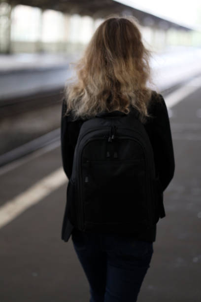 istock girl with a backpack at the train station 1285657187