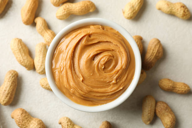 istock Bowl with peanut butter and peanut on white background 1285658716