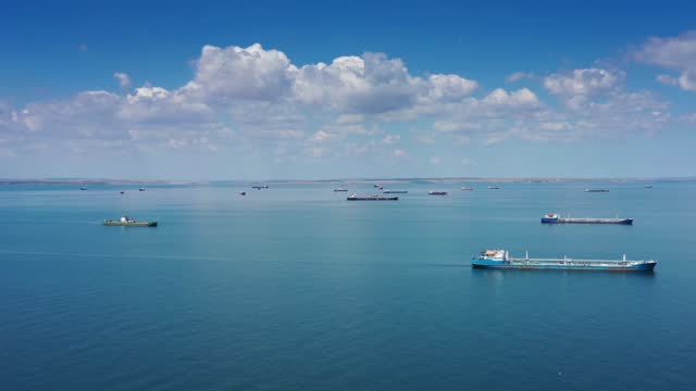 Aerial view of many cargo ships in sea