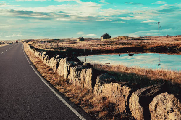 Morning autumn landscape between North Uist and Benbecula, part of the Outer hebrides of Scotland, showing two of the many deserted ruins on the island.