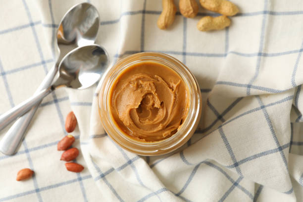 istock Napkin with peanut, jar of peanut butter and spoons 1285658965