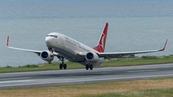 TRABZON, TURKEY - JULY 08, 2016: Turkish Airlines jet taking off from Trabzon airport in a windy weather.