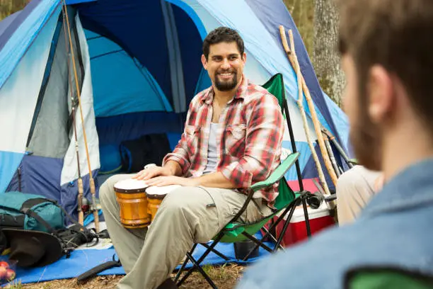 Multi ethnic group enjoying an adventure together as they hike, fish and camp out for a week of relaxation and rest.