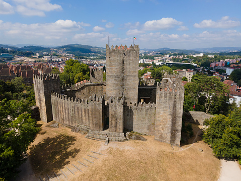 Guimarães, Portugal 28/7/2020: Guimarães Castle is connected to the birthplace of Portuguese nationality, it was here that King D. Afonso Henriques was born and founded the county of Portugal and the struggles for the independence of Portugal against the kings of Castile. The Castle is located on a hill and is classified as a national monument and represents one of the great historical landmarks of our country.