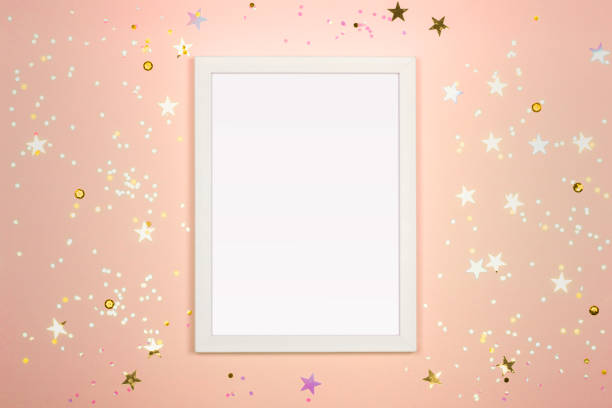 istock Festive background with blank white photo frame on light beige. 1285662996