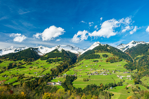Landscape with snowcapped mountains and the small mountain village St. Gerold in Vorarlberg, the most western state of Austria.