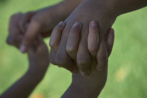 istock hands joined with love and friendship 1285667722