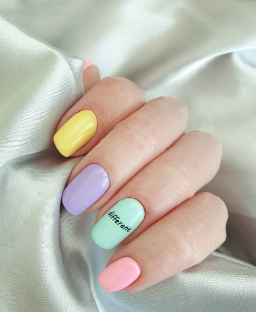 istock female hand beautiful colored manicure silk 1285667741