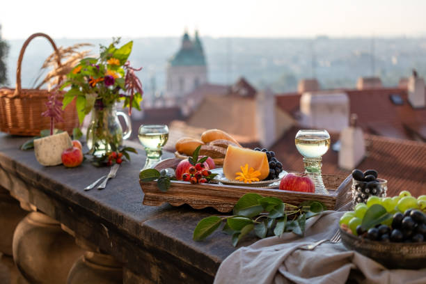 käse, äpfel und andere speisen auf einem balkon, mit einem panorama von prag im hintergrund - beautiful horizontal prague czech republic stock-fotos und bilder