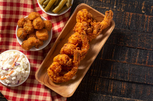istock Breaded and Fried Jumbo Shrimp with Tails on a Rustic Wooden Table 1285668176