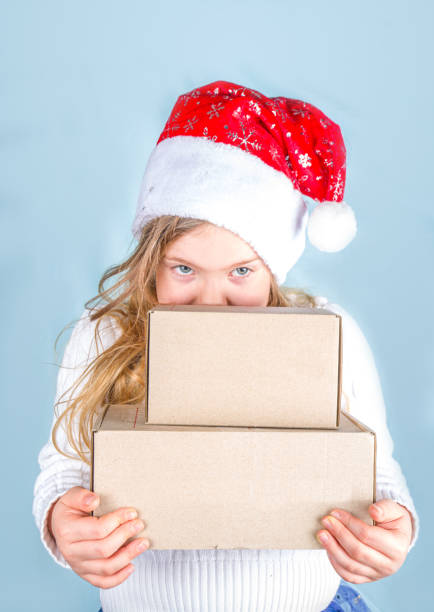istock Cute little girl with Xmas gift post parcels 1285670360