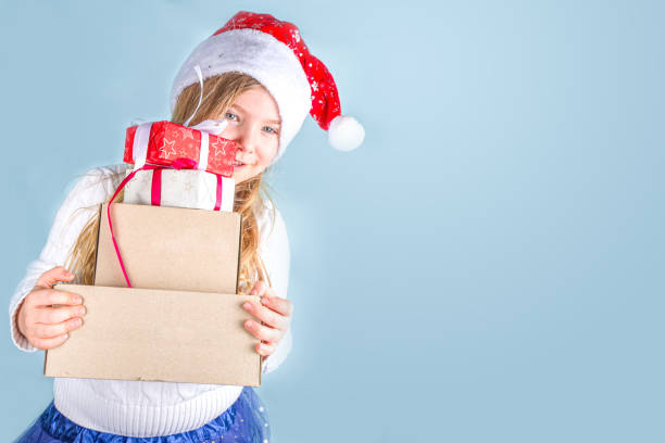istock Cute little girl with Xmas gift post parcels 1285670375