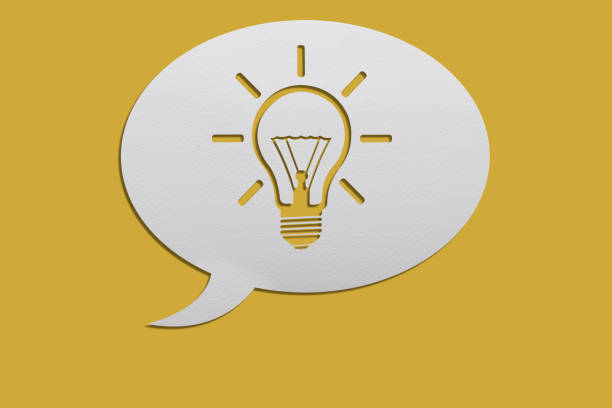 istock Light Bulb on a White speech bubble on yellow background with clipping path 1285671759